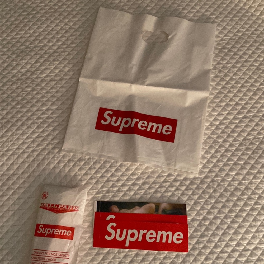 Three supreme stickers, supreme poncho, supreme bag